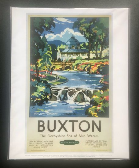 Vintage travel poster for Buxton featuring a scenic view with a stream and greenery.